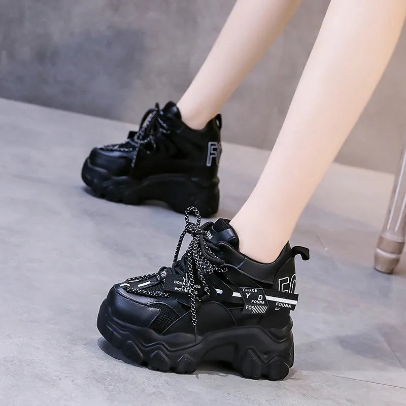 White women's low-top platform sports shoes with a cross-strap and breathable mesh upper on a rubber sole.