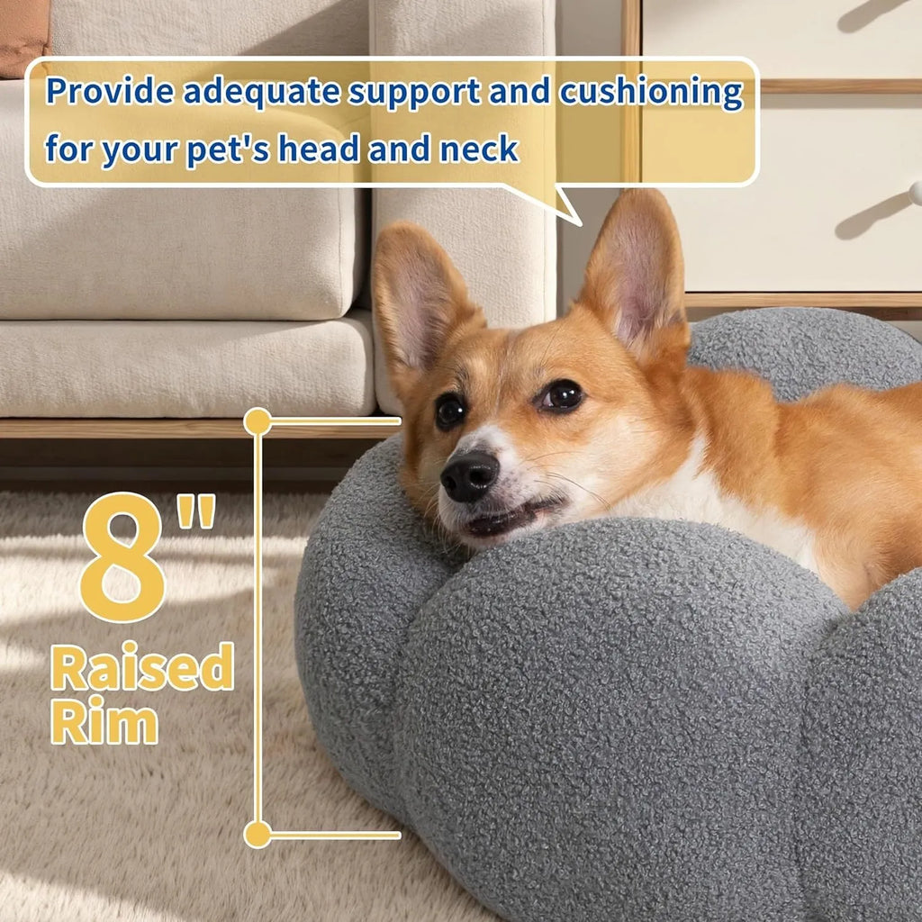 White fluffy flower-shaped pet bed with raised teddy fleece edges and round donut design on a light floor