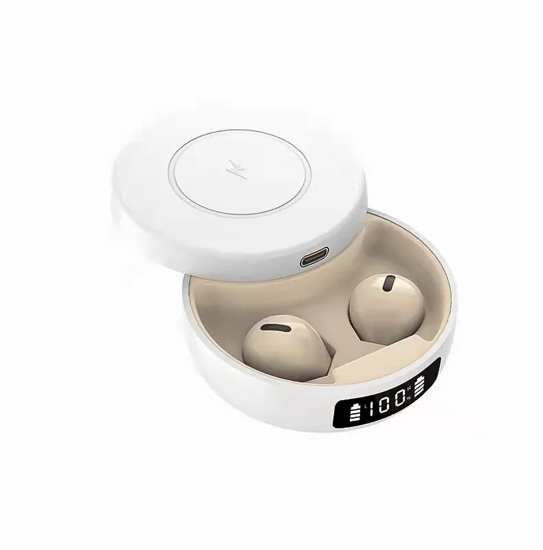Mini black semi-in-ear wireless headphones with their compact wireless charging case on a table.