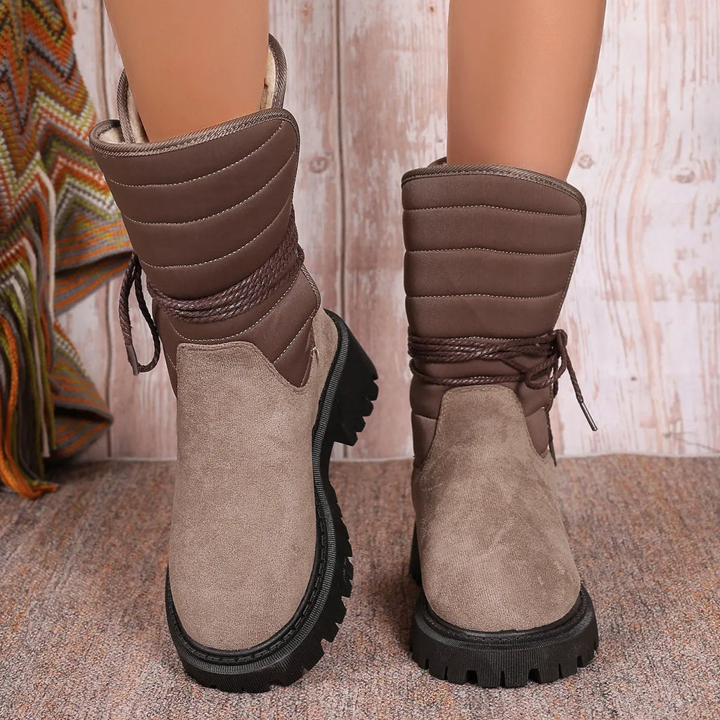Women's black chunky heel snow boots with lace-up design and fleece lining on a high-top suede upper.