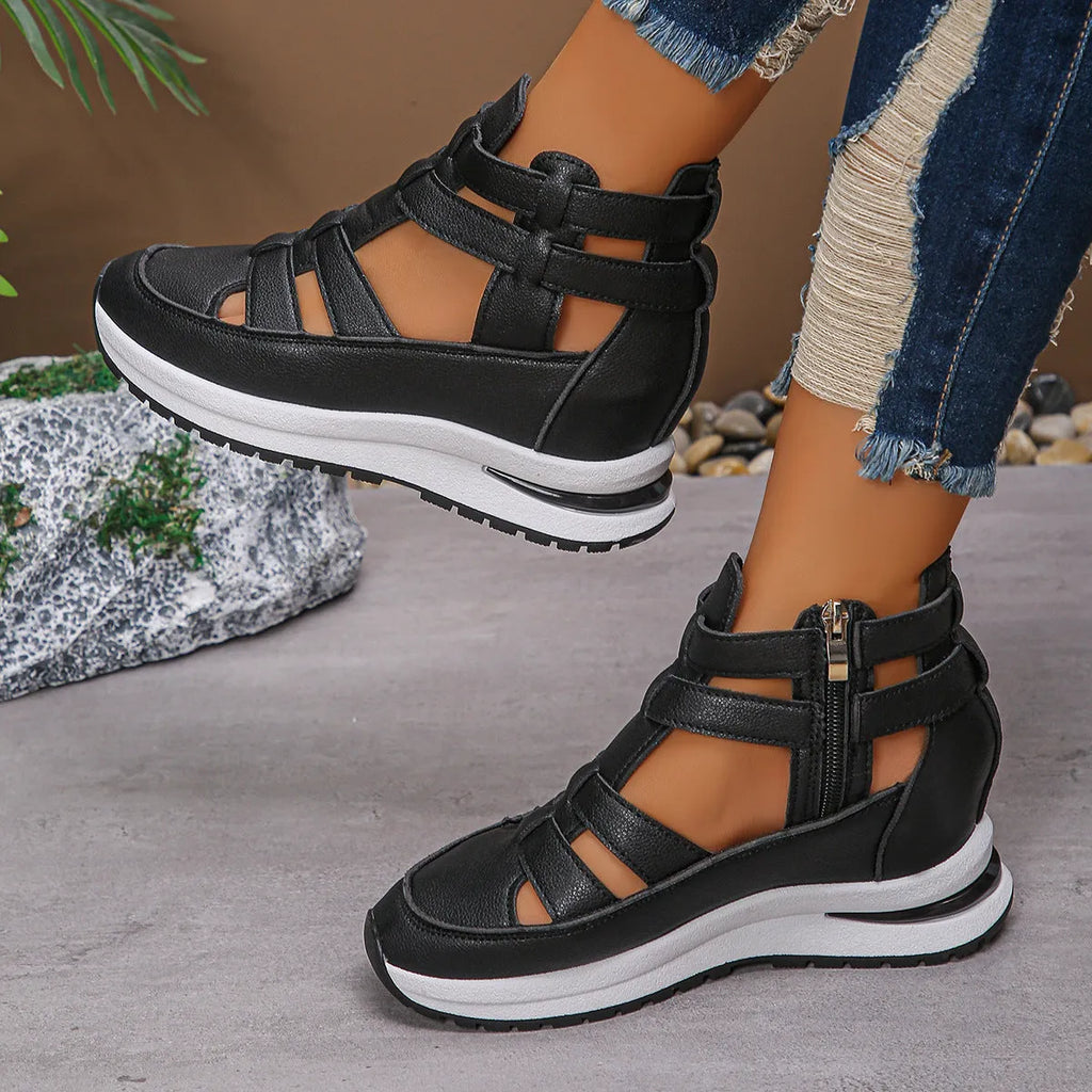 Women's black platform sandal with closed toe, hollow-out design, and Velcro ankle strap.