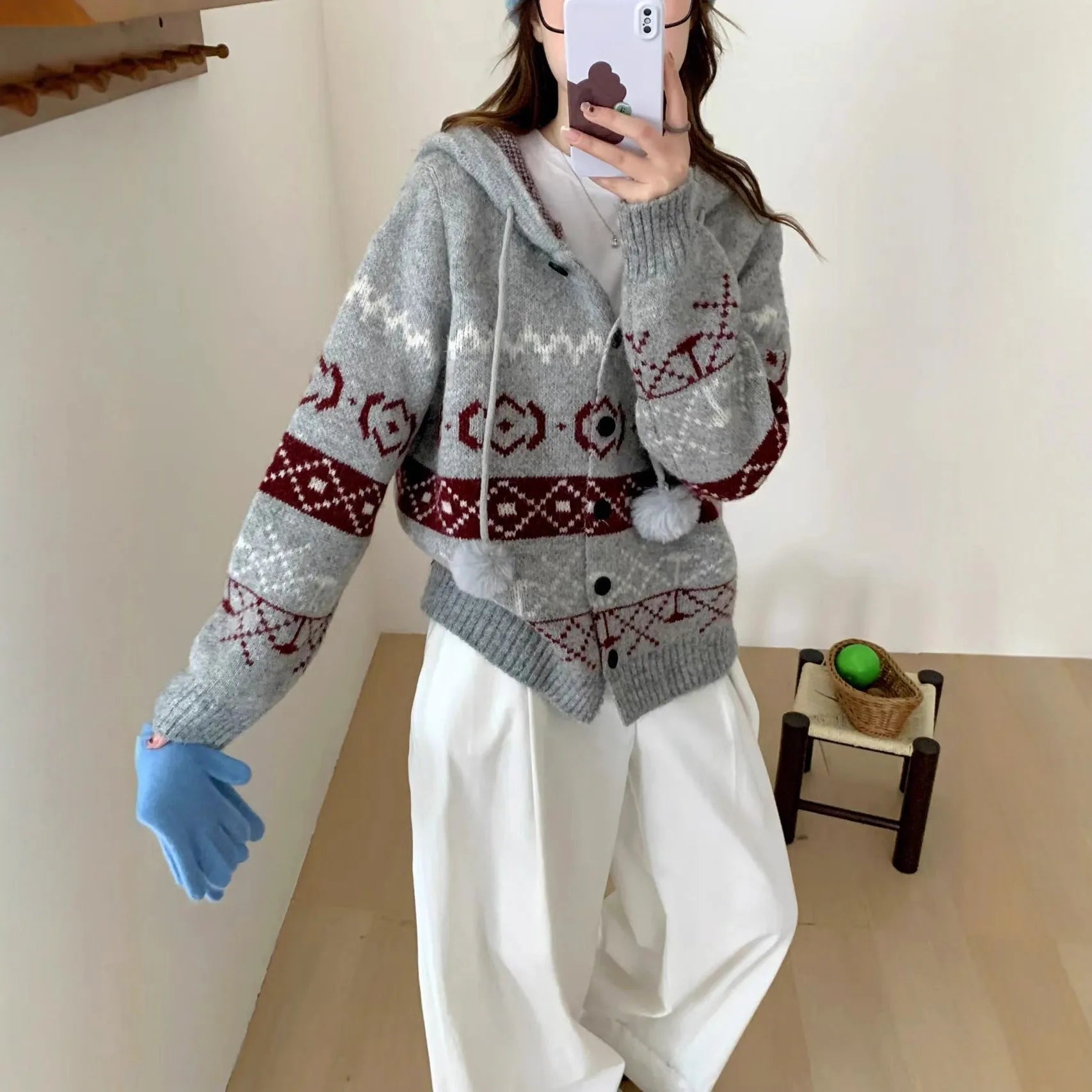 A beige, loose-fitting brocade knit sweater coat for plus size women with a geometric pattern.
