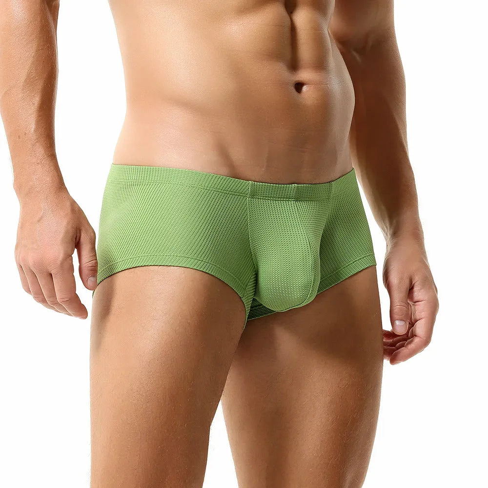 Solid colour low waist men's boxers in nylon fabric on a white background