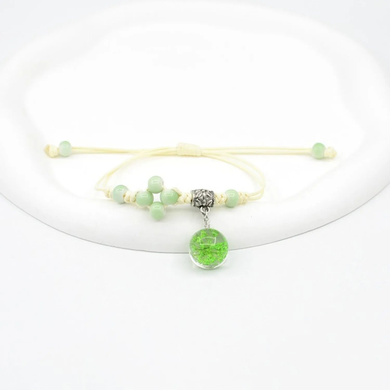 Hand-woven glass bracelet with large beads containing real dried flowers, shown in multiple colour options.