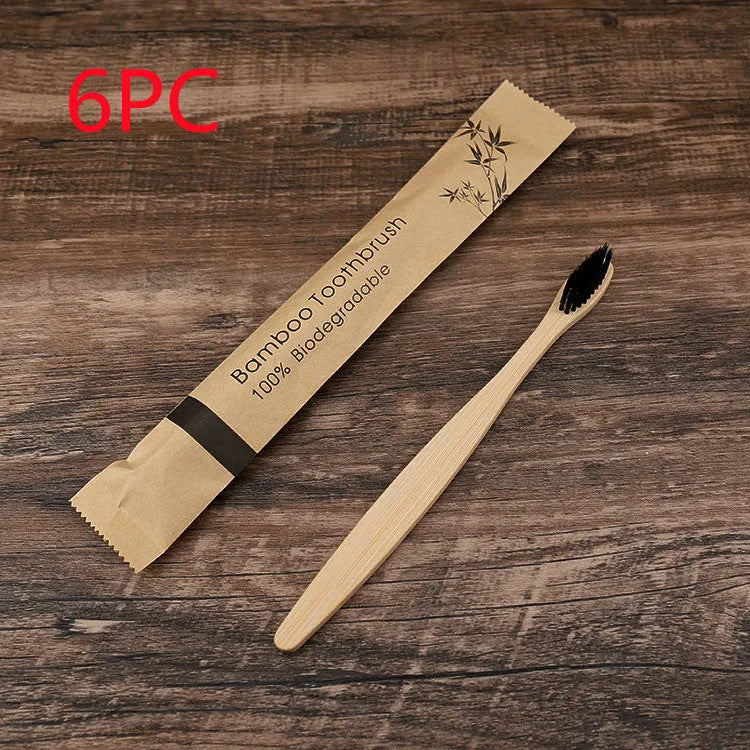 Set of ten bamboo toothbrushes with charcoal bristles in assorted colours on a plain background