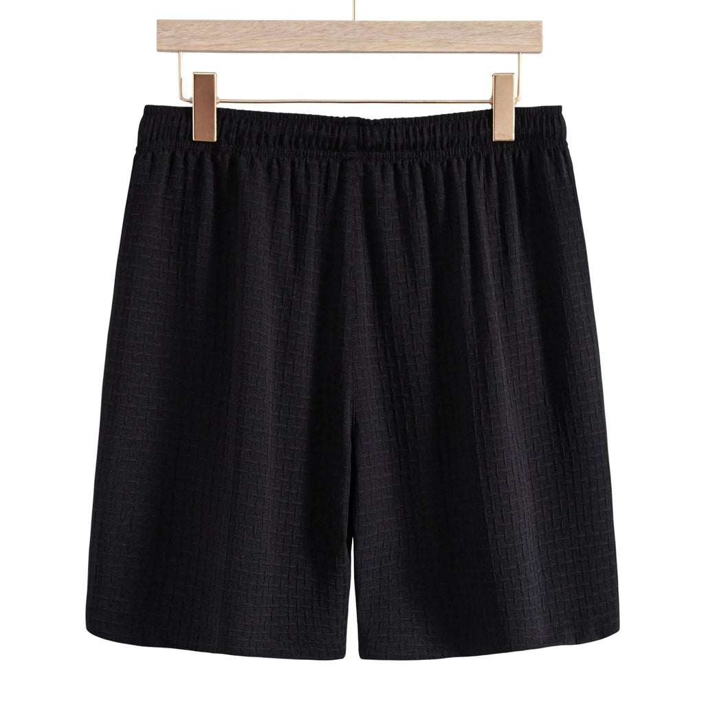 Men's black cotton blend beach suit with loose cardigan shirt and matching shorts.