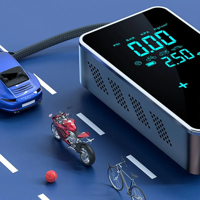 Compact black wireless car tyre pump with LCD screen on a cloth bag alongside its charging cable and nozzles.