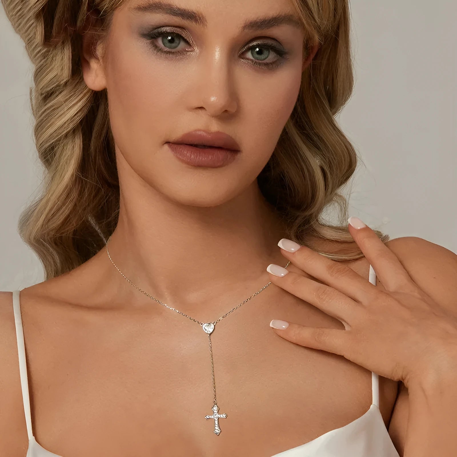 Women's silver love cross necklace with V-neck pendant on O-ring chain.