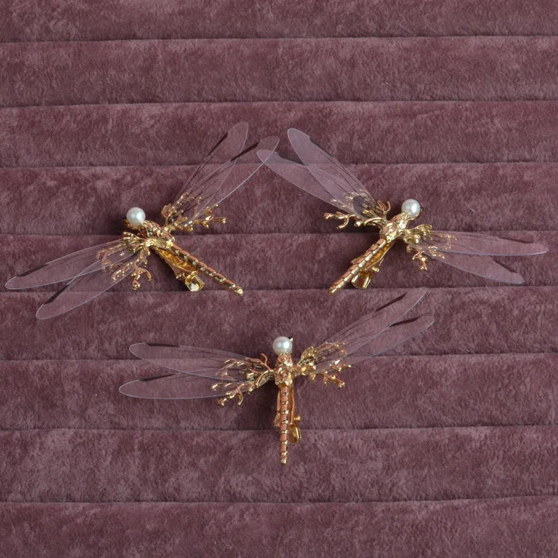 Golden dragonfly-shaped women's headdress with side clip on white background