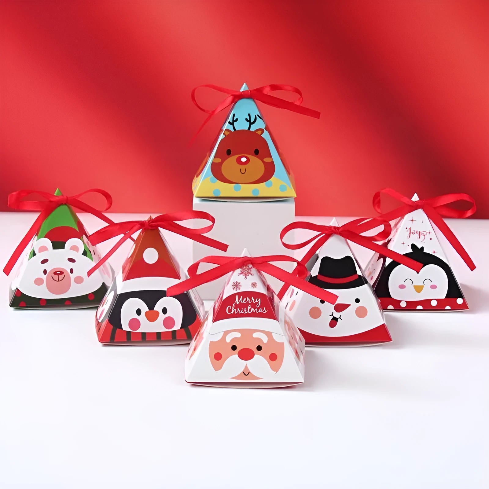 Christmas triangle candy box in paper with festive Santa and snowman print and ribbon ties