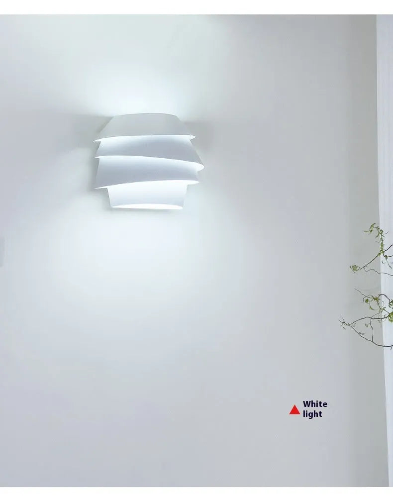 White modern wall lamp with pine cone silhouette design for bedroom or hallway lighting