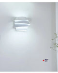 White modern wall lamp with pine cone silhouette design for bedroom or hallway lighting