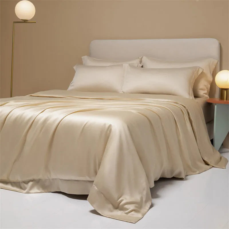 Luxury Lenzing Tencel bedding set in Aurora Blue on a bed, showing quilt cover, sheet, and two pillowcases.