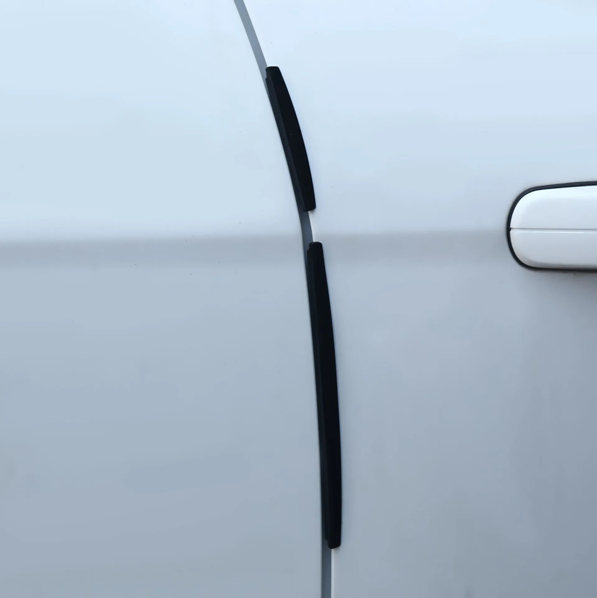 Solid white plastic car door edge protection bumper strip, one set shown.