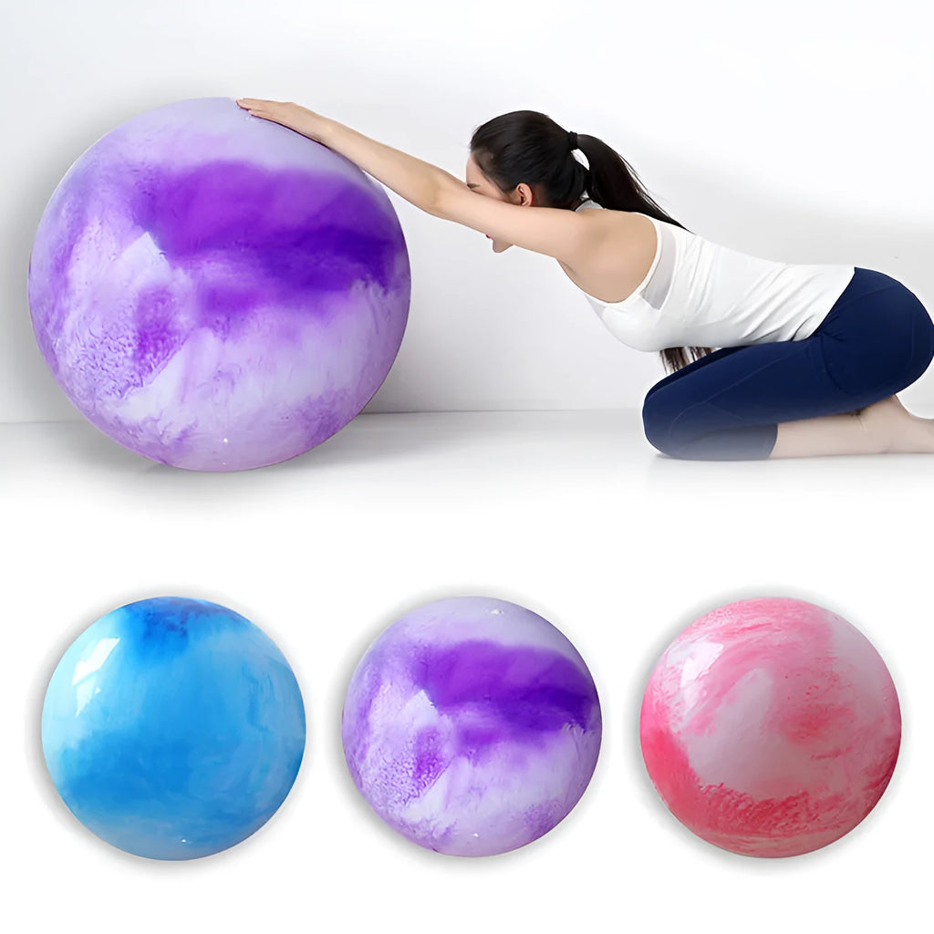 Colourful polyvinyl chloride yoga ball on floor for pilates and stretching exercises