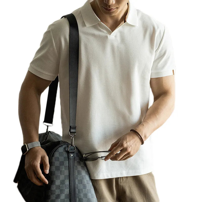 Blue short-sleeved polo shirt on a hanger, showing regular fit and cotton-polyester fabric blend.