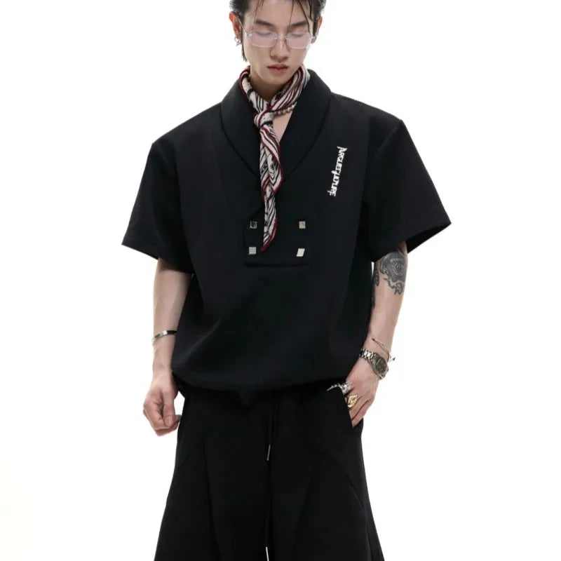 Men's dark grey cotton sports suit with padded shoulders, featuring a V-neck short-sleeve shirt and matching shorts.