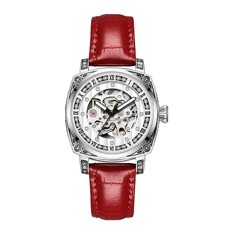 Men's black leather strap mechanical watch with luminous hands on a wrist.