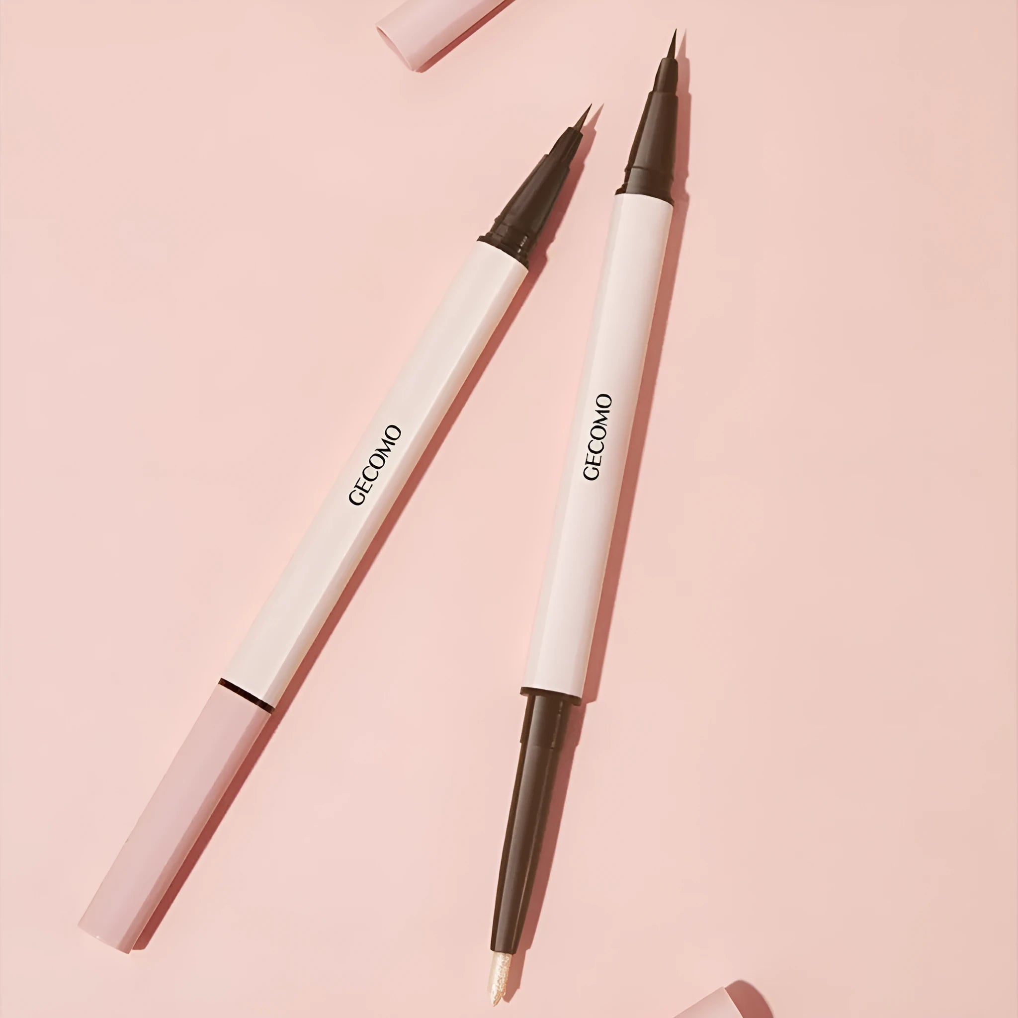 Double-headed silkworm pen eyeliner showing Floating Platinum and Born Nude Apricot colours