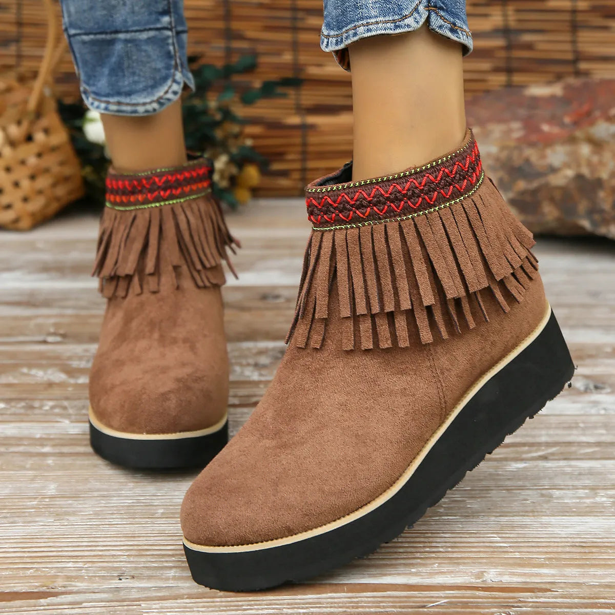 Women's suede wedge ankle boot with tassel detail, side zip, and a thick rubber sole.