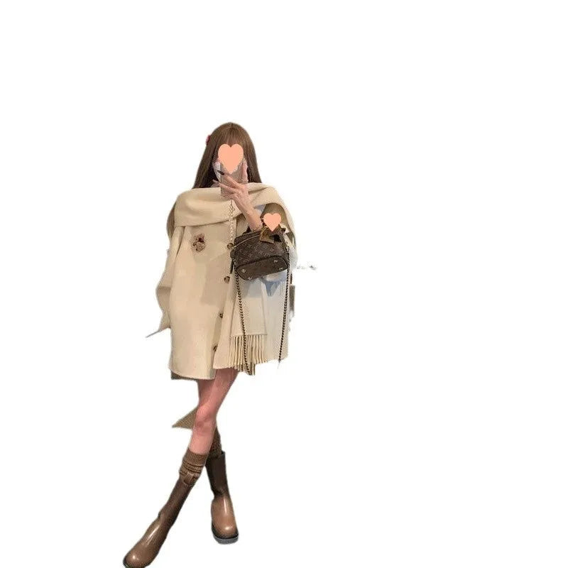 Gold Cloak loose-fitting tassel woolen coat in cream white on a female model