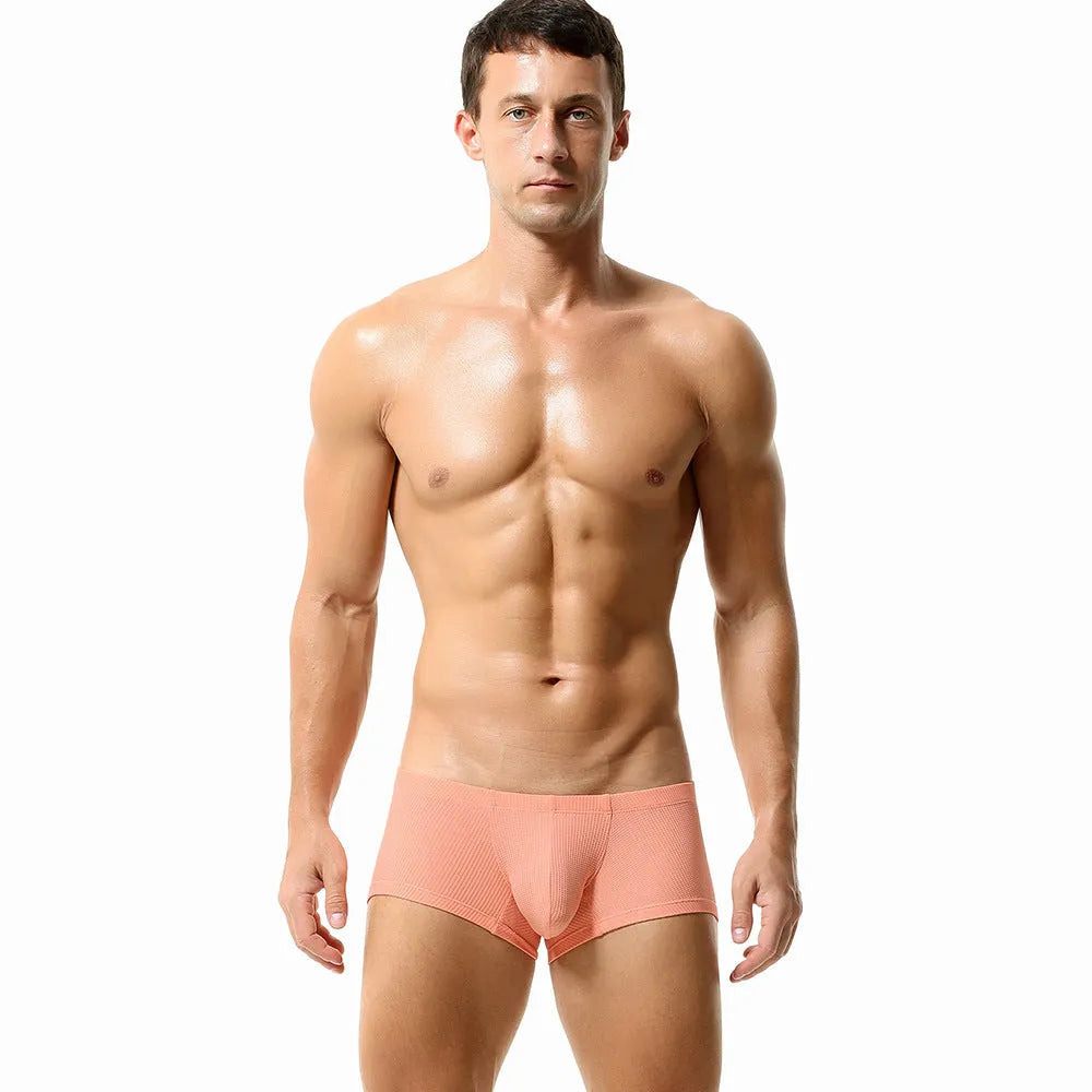 Solid colour low waist men's boxers in nylon fabric on a white background