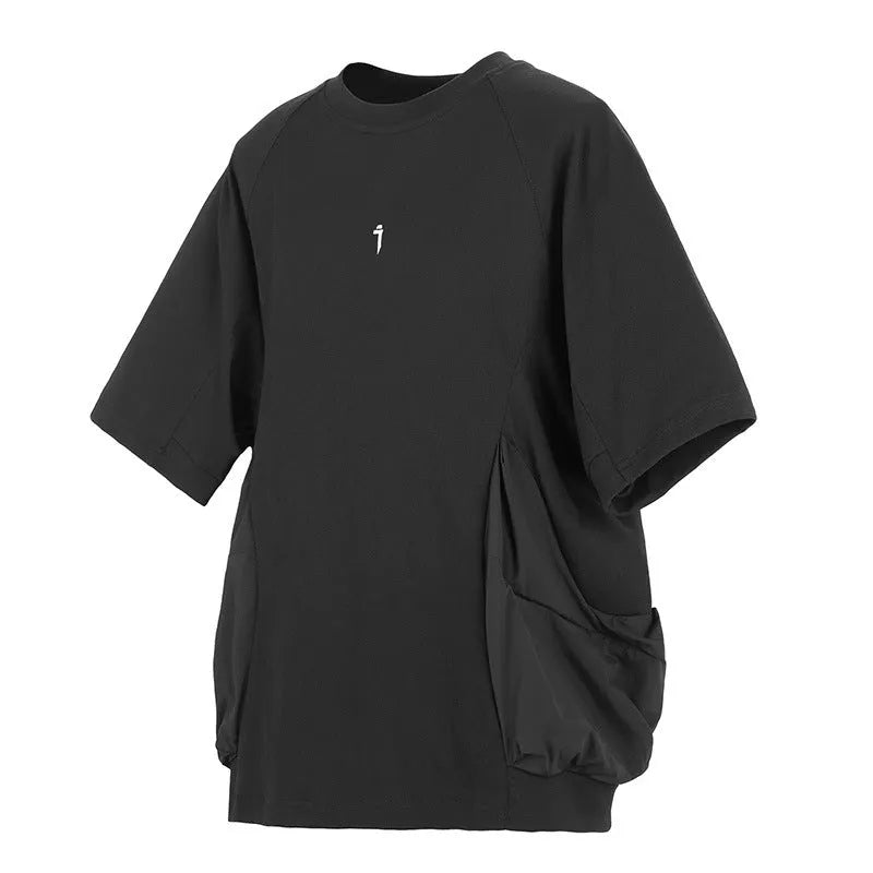 A man's loose black cotton T-shirt with large chest pockets and short sleeves.