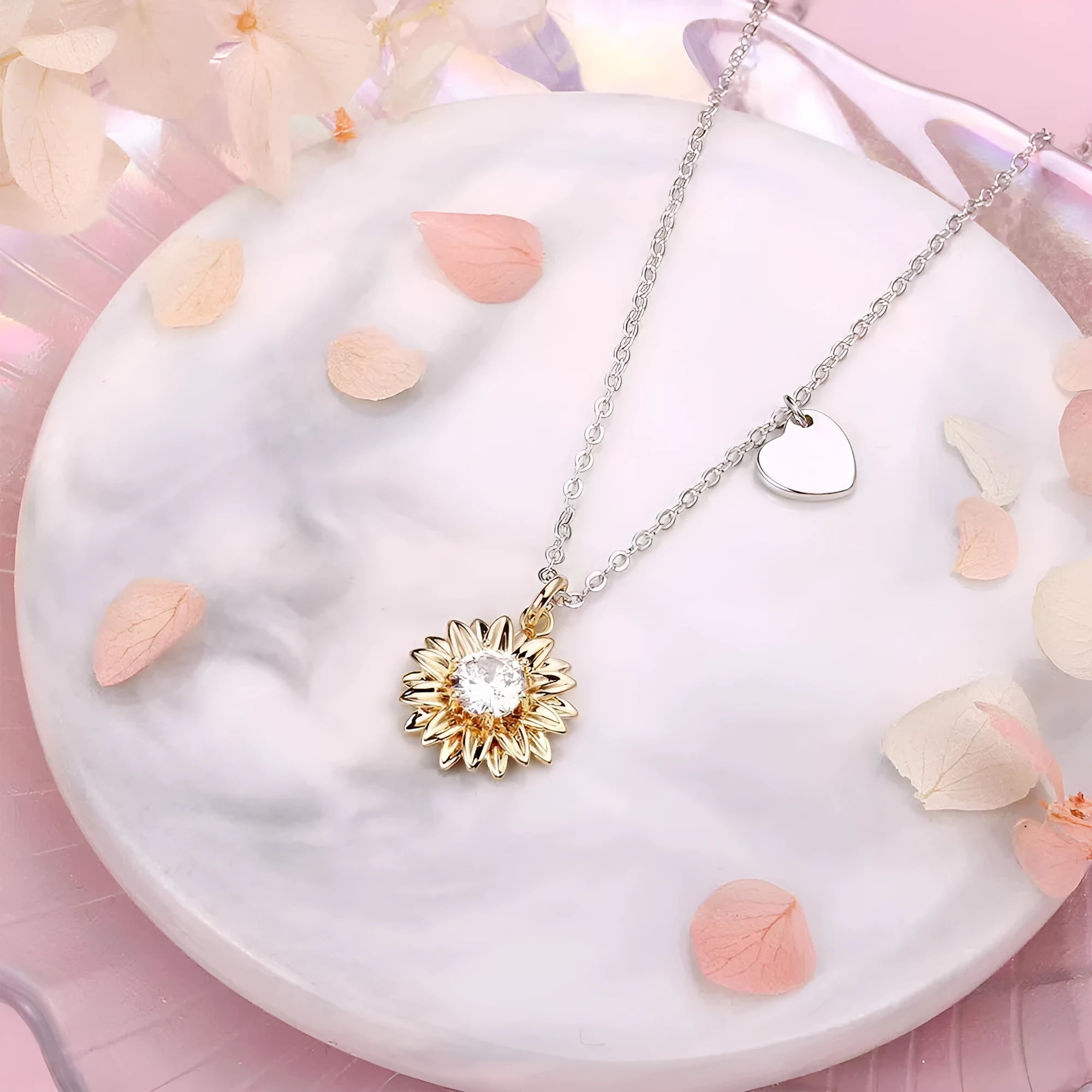 Close-up of a geometric sunflower pendant necklace on an adjustable silver cross chain.