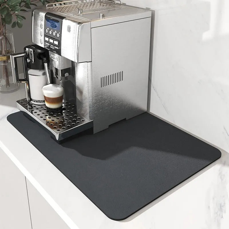 Black square kitchen drain drying mat with anti-slip rubber backing on a countertop