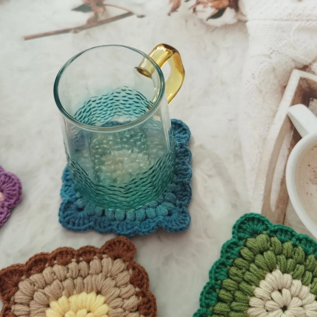 Handcrafted crocheted wool coaster with Grandmother Lattice stitch in a purple colour.