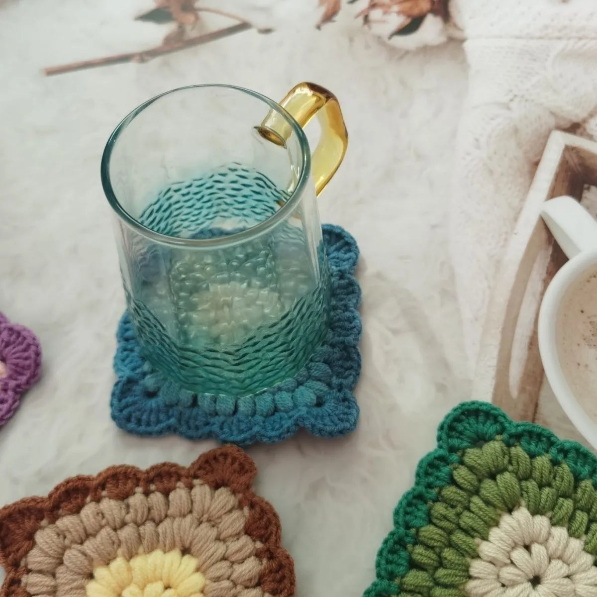 Handcrafted crocheted wool coaster with Grandmother Lattice stitch in a purple colour.