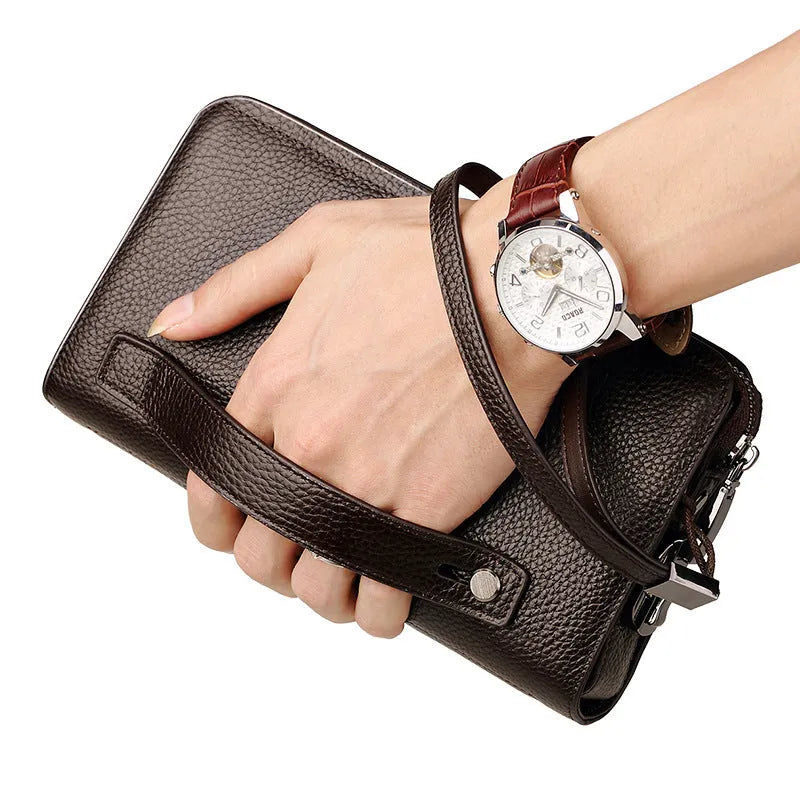 Men's black genuine leather clutch wallet open to show internal card slots, phone pocket, and zippered compartment.
