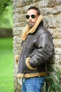 Men's brown retro western-style synthetic leather winter coat with side pockets on a mannequin.