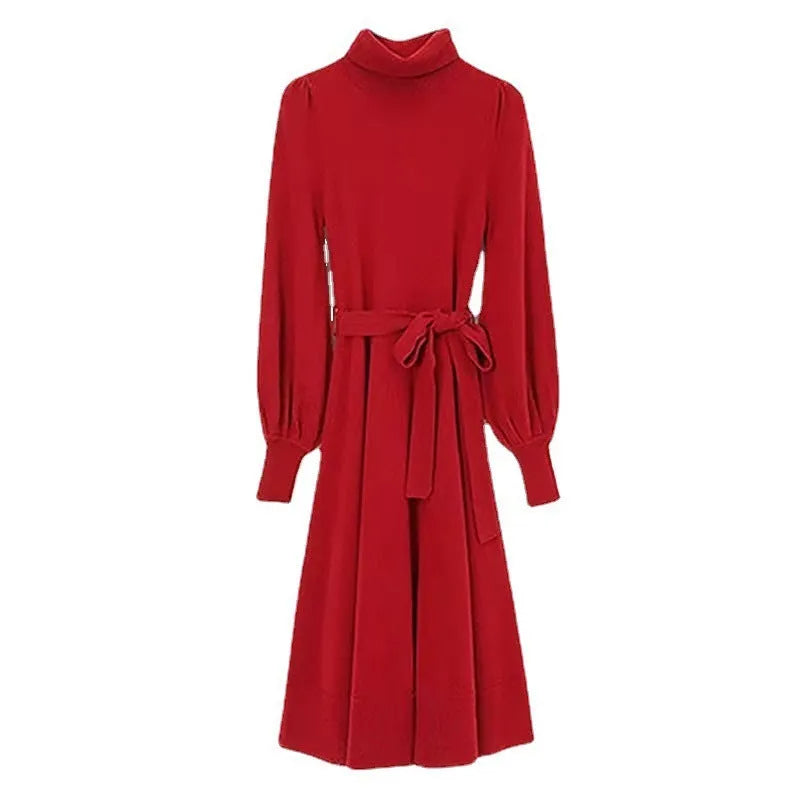 Woman wearing a rose red turtleneck knitted dress with long sleeves and a loose, flared big hem.