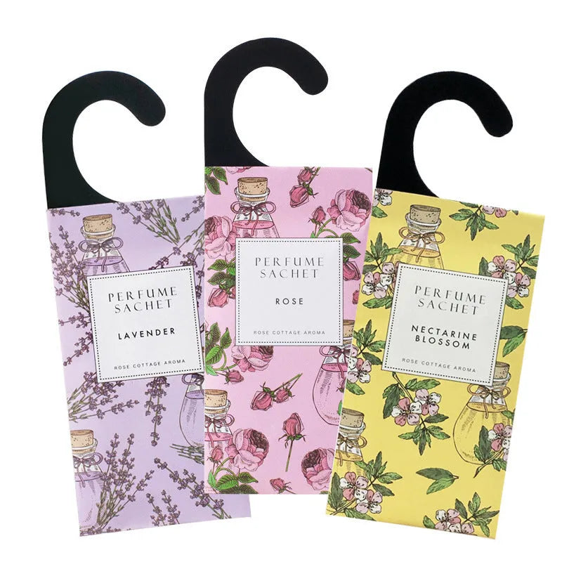 Pack of five household wardrobe sachets with lavender, rose, jasmine, sandalwood, vanilla, apricot blossom aromas on a shelf