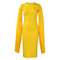 Yellow high-waisted evening gown with long sleeves and a full pleated skirt, model standing formally.