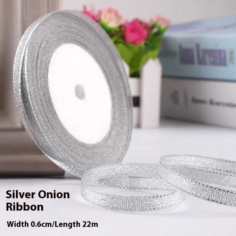 Roll of narrow 0.6cm wide polyester gift ribbon in a multicolour pattern.