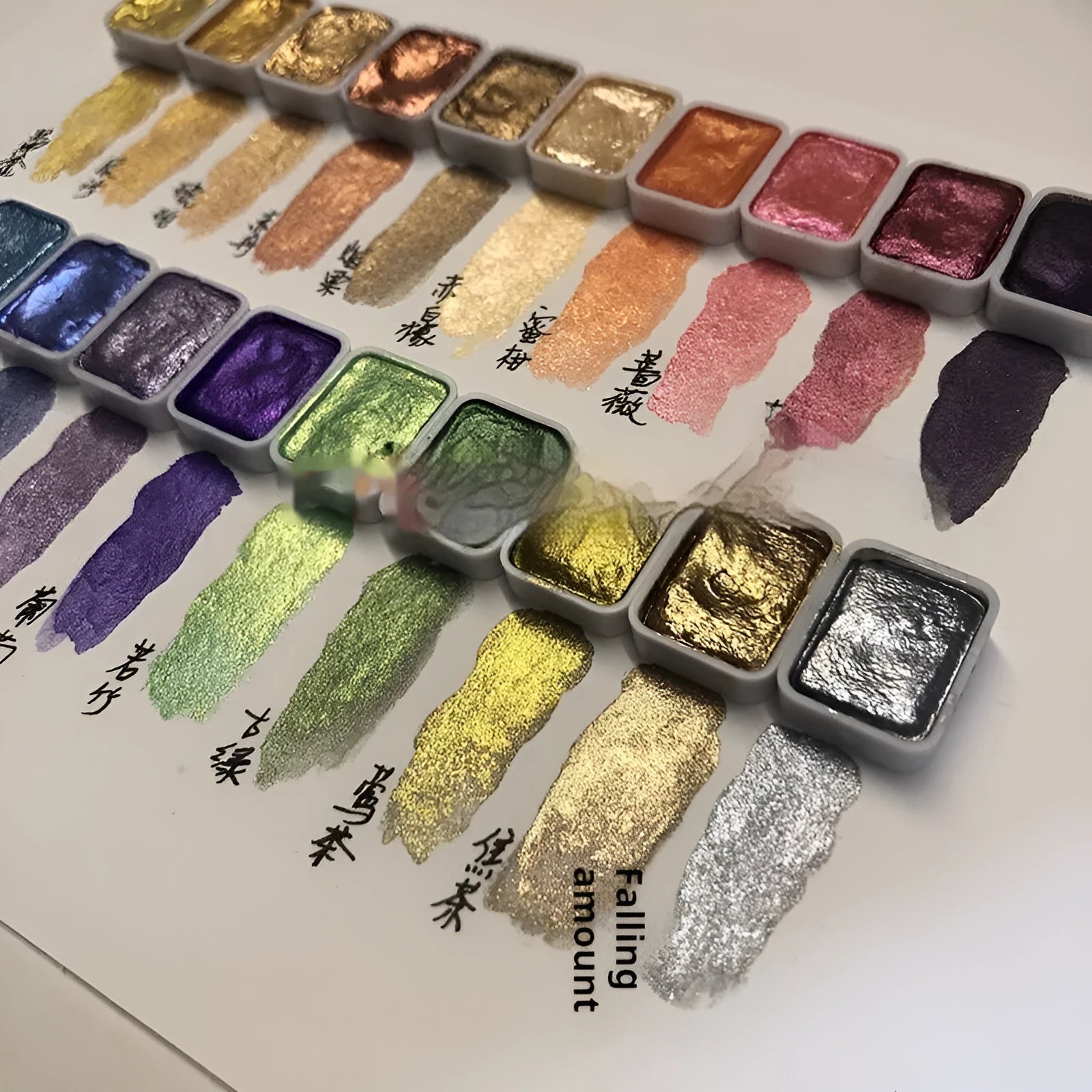 Traditional Chinese painting watercolour set showing pots of red, white gold, warm, and cold colour paints.