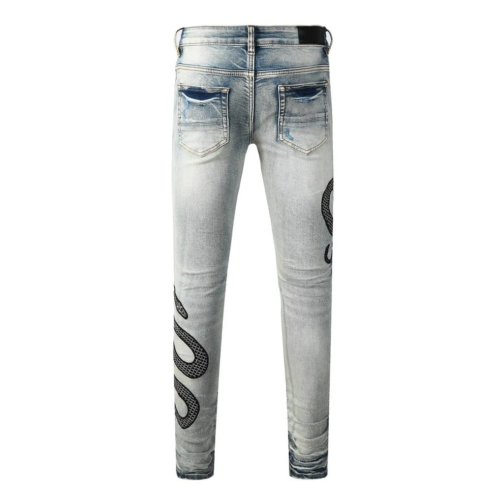 Blue distressed street fashion skinny jeans with a button fly and tight leg fit.
