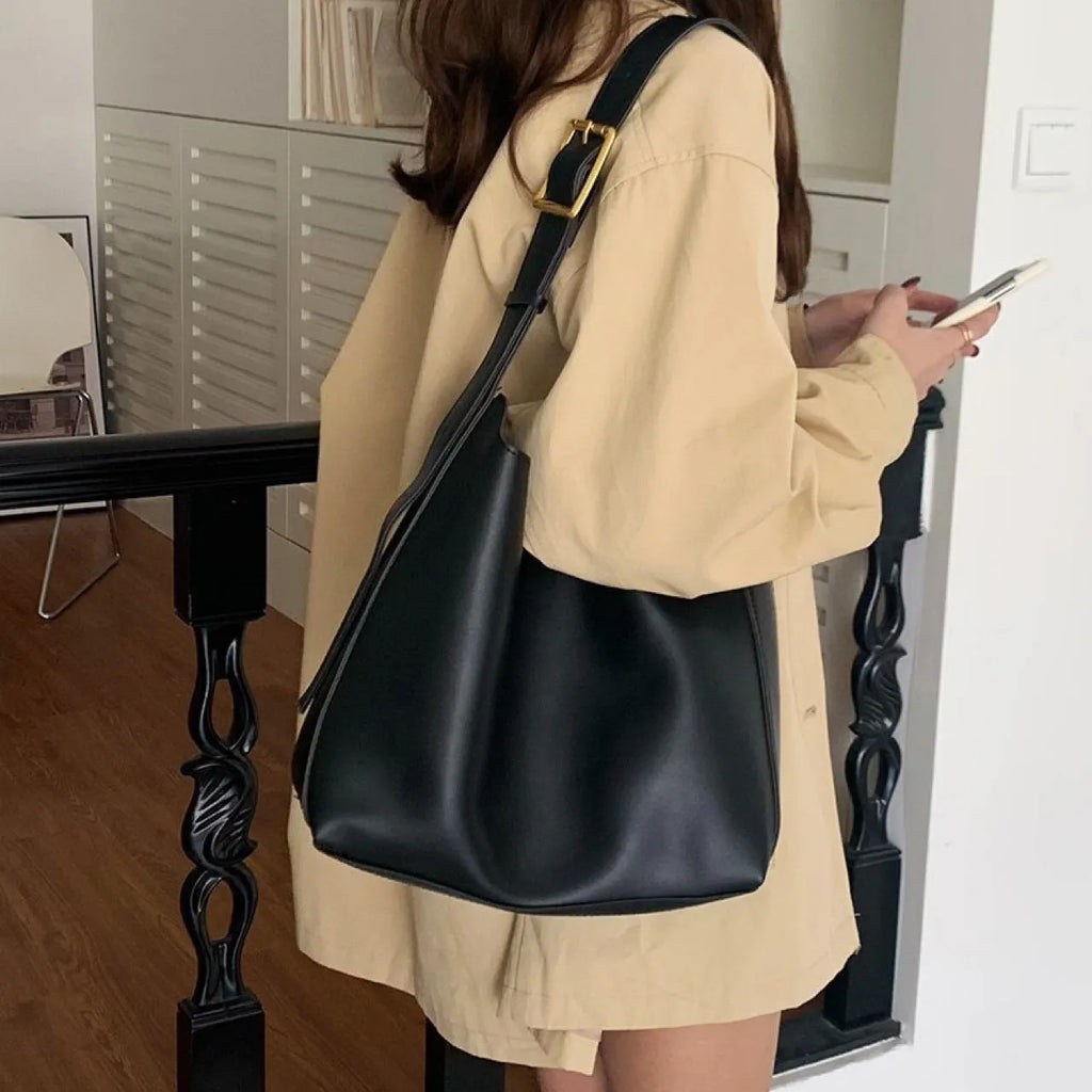 Women's soft PU shoulder bag with swing threads decoration showing black and brown colour options