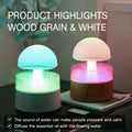 White cloud-shaped ultrasonic aroma diffuser and humidifier with simulated raindrops and coloured lights.