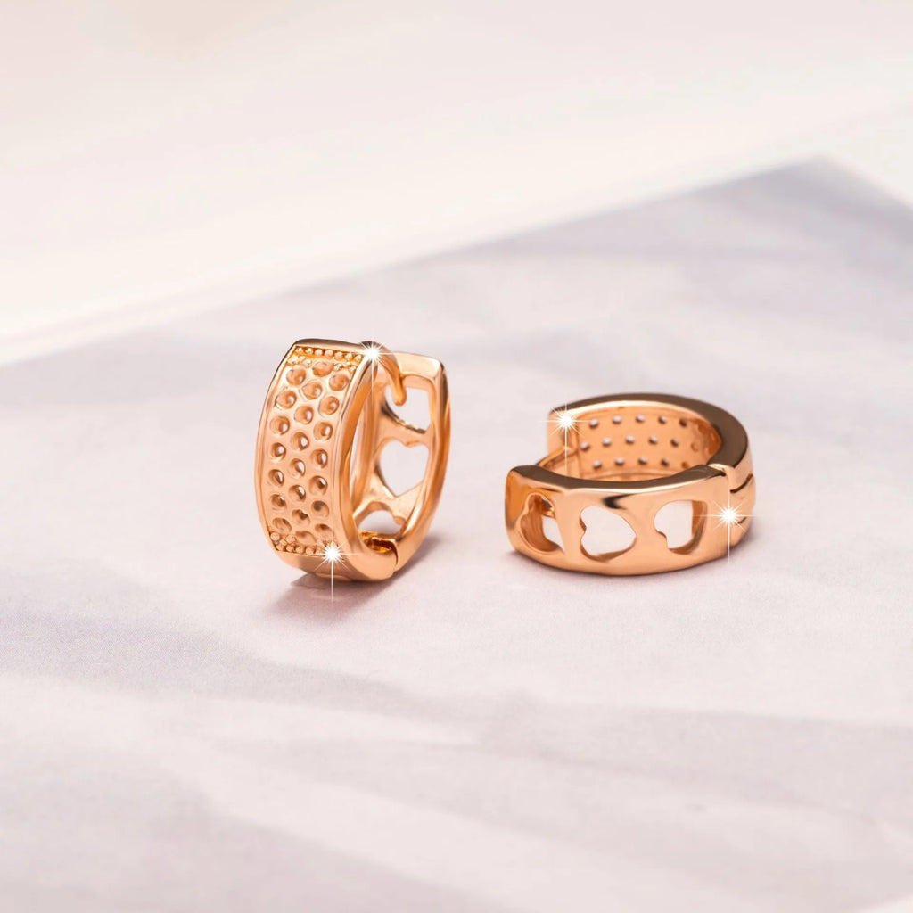 Rose gold women's earrings featuring a hollow heart shape inside a circular frame.