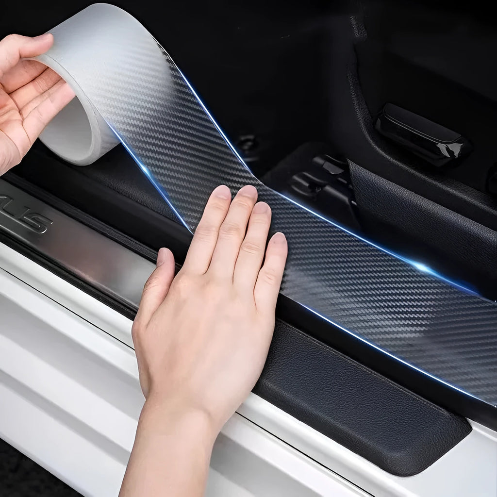 Roll of transparent carbon fibre grain car protection strip with scraper and utility knife.