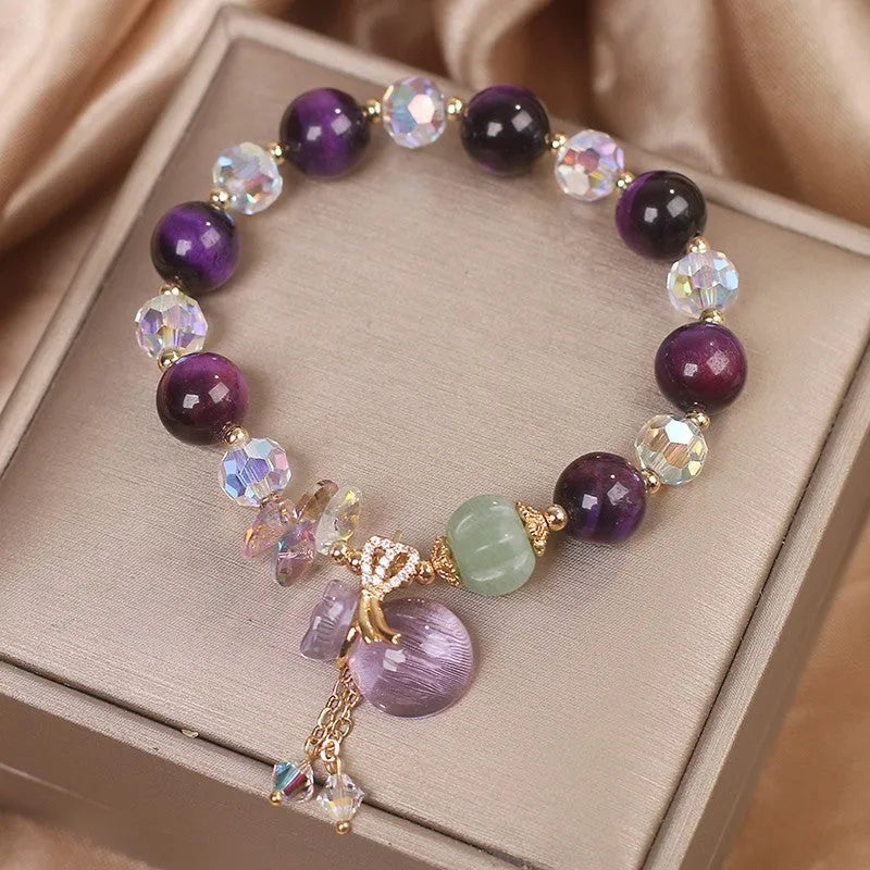 Women's forest style crystal bracelet with purple Tigereye money bag pendant and rhinestone details