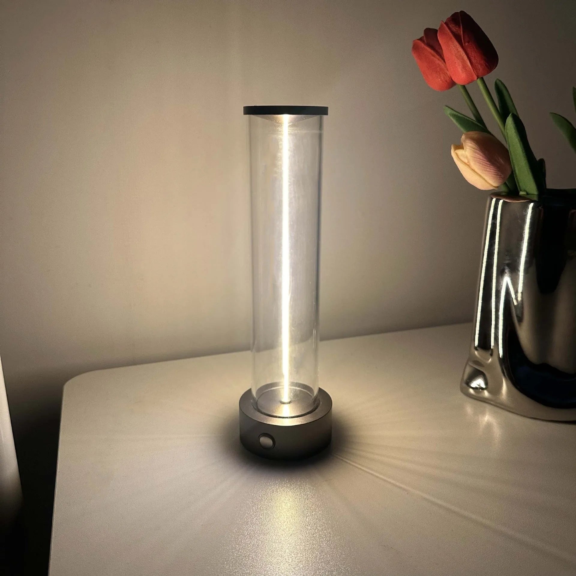 Modern glass USB LED night light with magnetic strip on a metal surface.