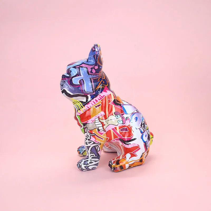 Graffiti coloured solid resin French bulldog statue on a wooden surface.