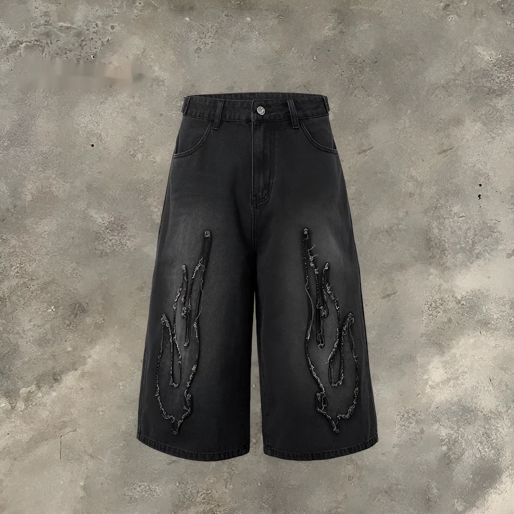 Men's black denim shorts with flame embroidery patch detail on straight leg cropped design