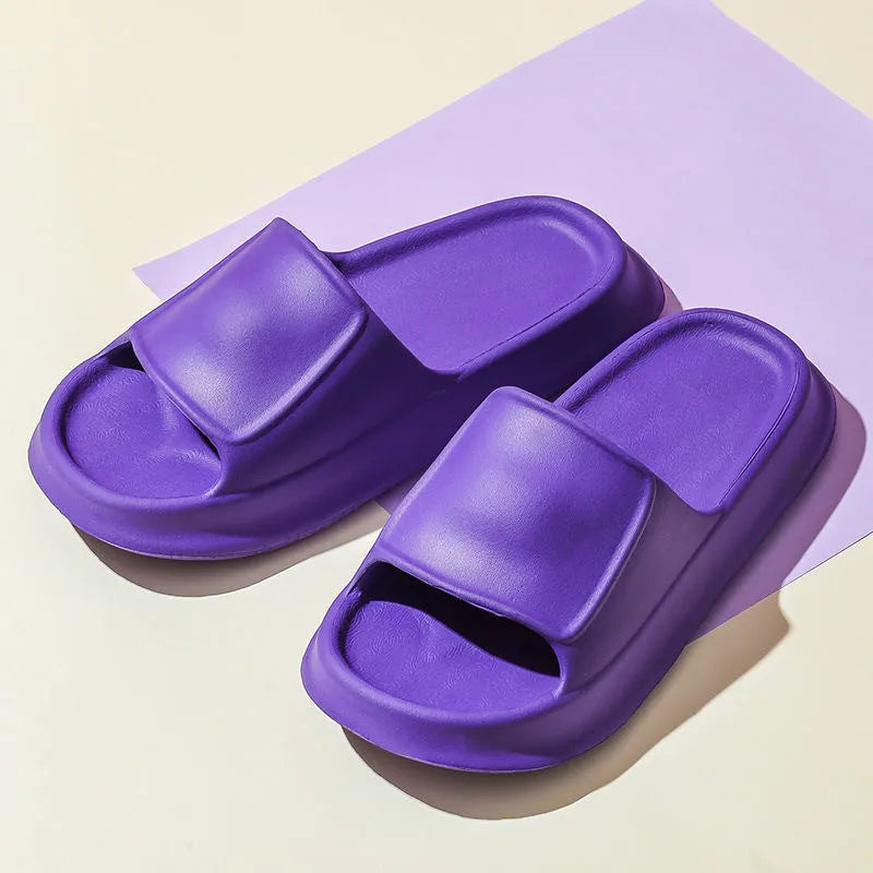 A pair of thick-soled EVA flip-flop slippers on a bathroom floor, showcasing non-slip tread and available colour options.