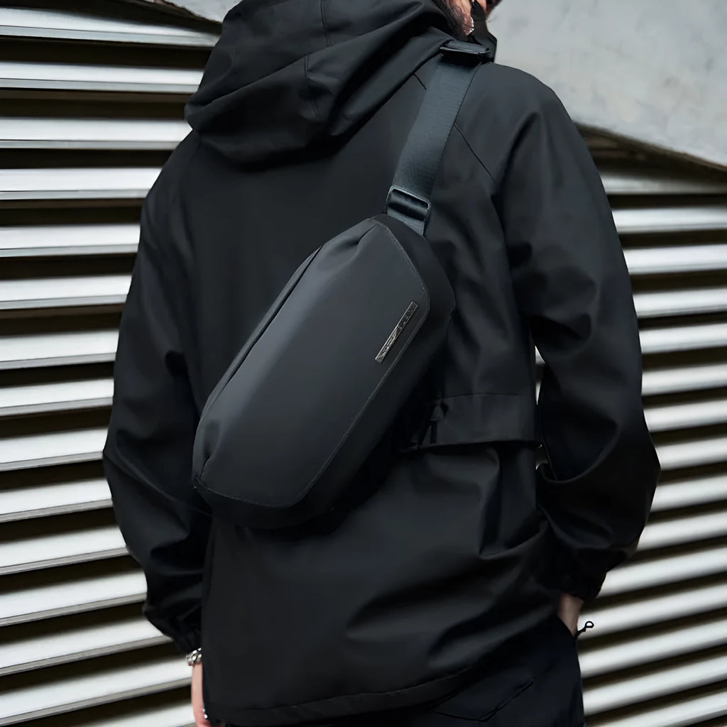 Black oxford cloth men's messenger bag with a one-shoulder cross-body strap.