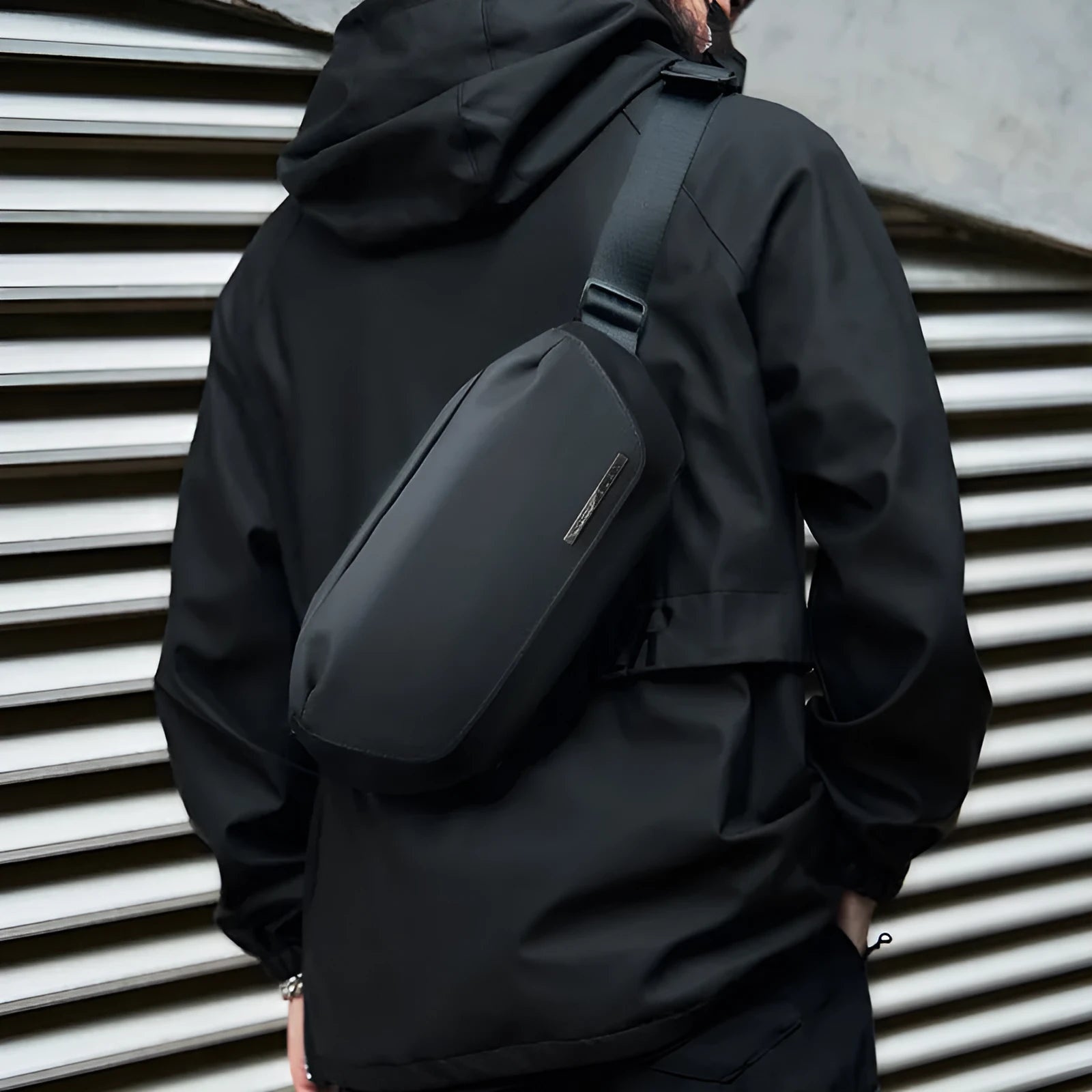 Black oxford cloth men's messenger bag with a one-shoulder cross-body strap.